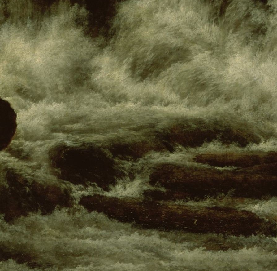 The rocks are wet and rough from the water.