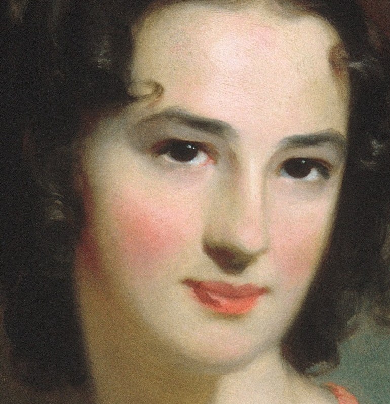 Her direct gaze and rosy cheeks convey a sense of gentle confidence and approachability.
