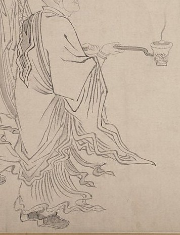 This monk holds a censer, used in rituals to purify and honor.