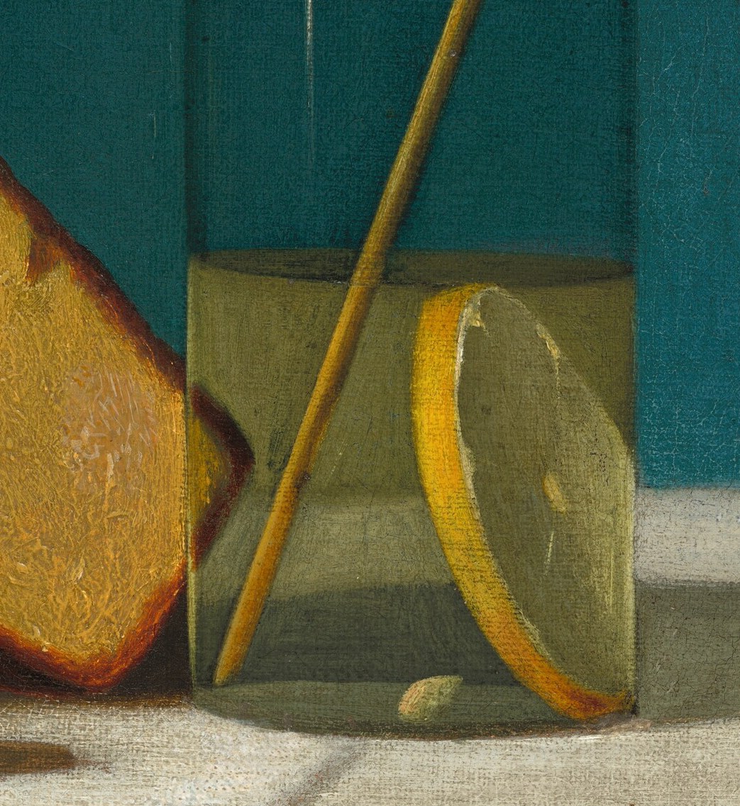 A refreshing drink, a lemon slice floating in the glass.