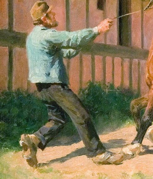 A man struggles to control these spirited horses.