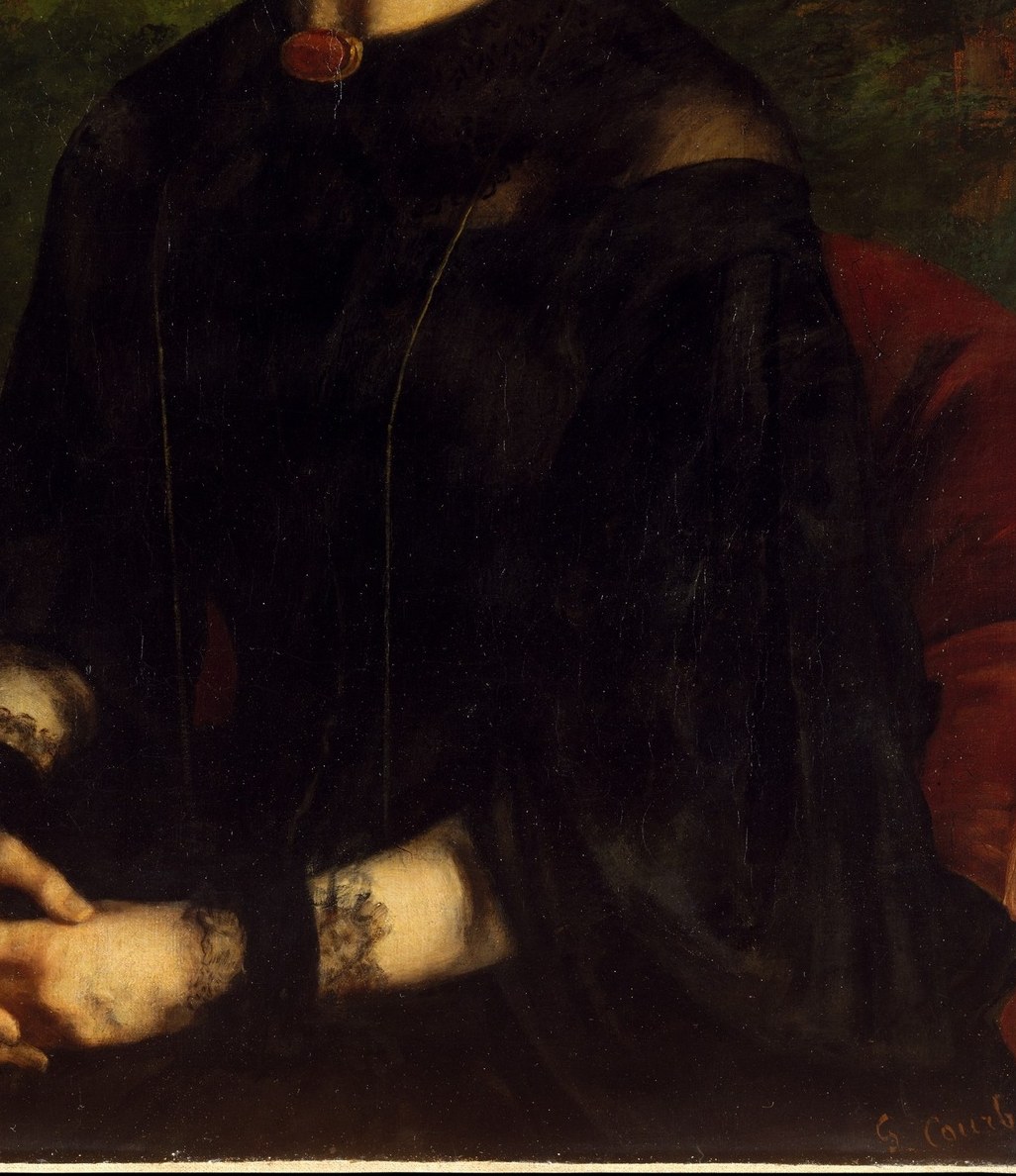 Her plain, dark dress suggests a quiet elegance.