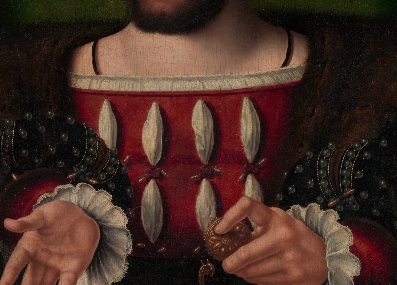 Ermine tails cover his chest. Only a king could wear them.