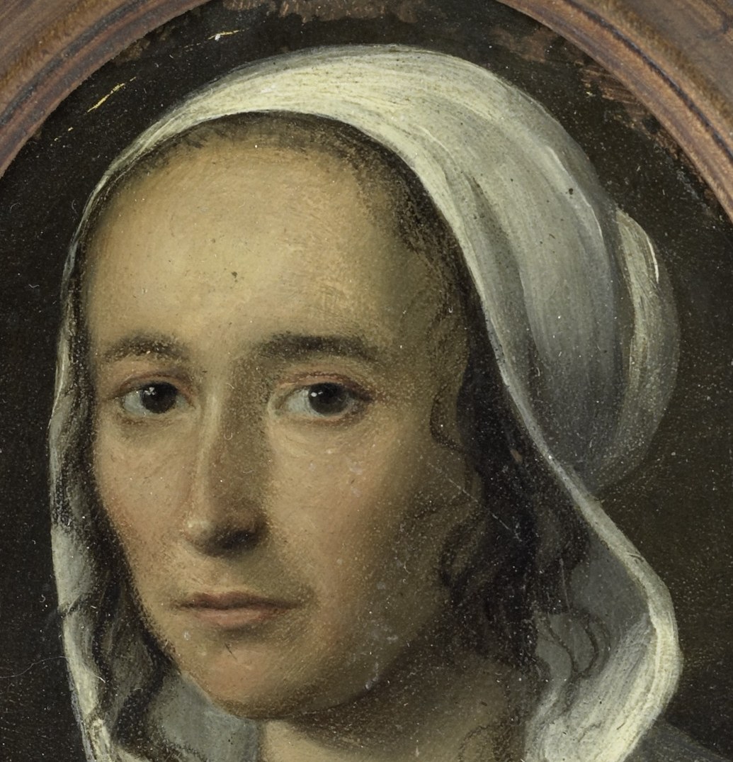 The soft folds of the cap frame her face and highlight the pale skin, typical of Dutch Golden Age portraits.