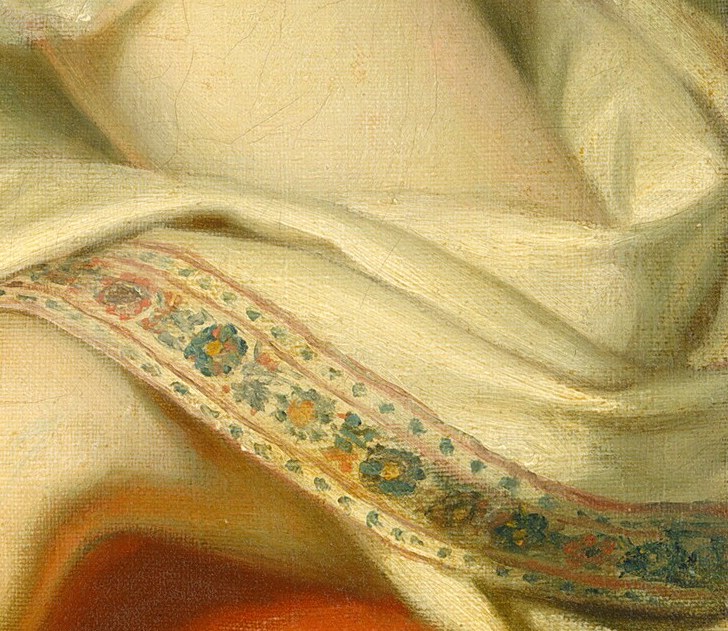 Notice her ornate, patterned sleeve cuff.