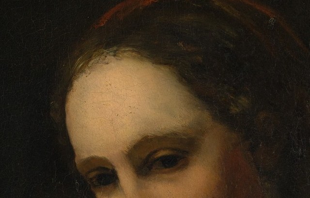 Her eyes find the viewer anyway.
