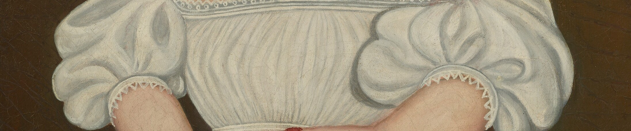 The trim on her dress is finely detailed.