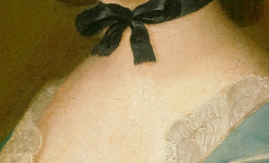 A recurring accessory in mid-18th century women's portraits; signals fashionable awareness and provides a stark counterpoint to the pale skin above.