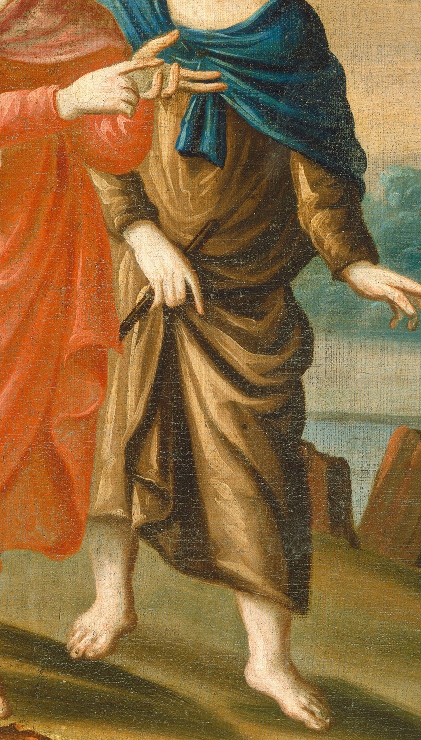 His expression and outstretched hand show engagement and perhaps surprise.