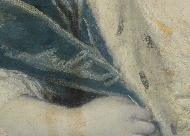And her hands, clasped quietly, hold no ring.