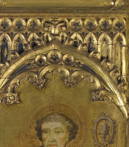 The saint's halo becomes a mirror in a dark church.