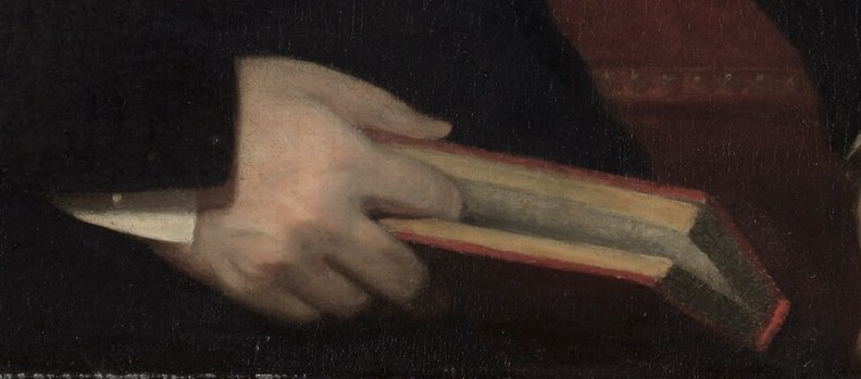 His delicate grip on this book suggests a scholarly nature.