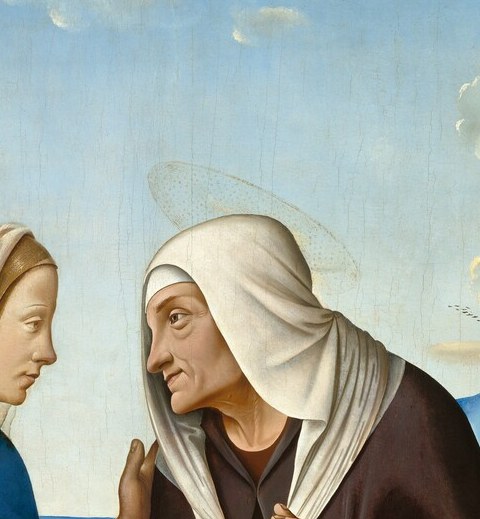 Older, lined face conveys wonder and reverence; the generational contrast with Mary is legible in a single close-up.