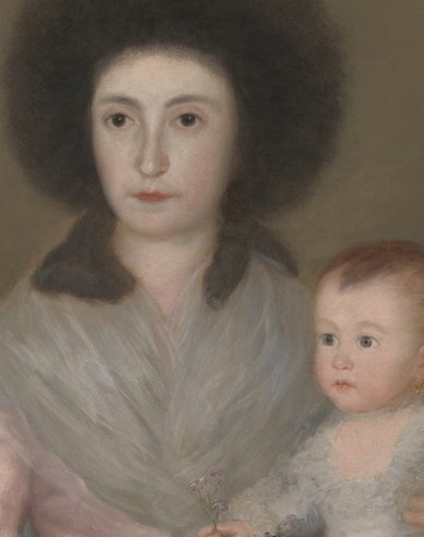 The child looks outward with wide, direct eyes , unusual alertness for an infant, creating an uncanny, adult-like presence