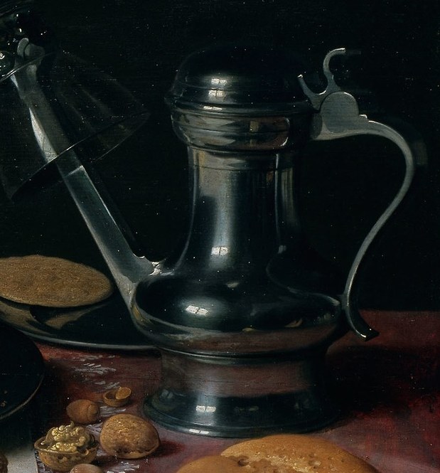 Look closely at the polished metal pitcher.