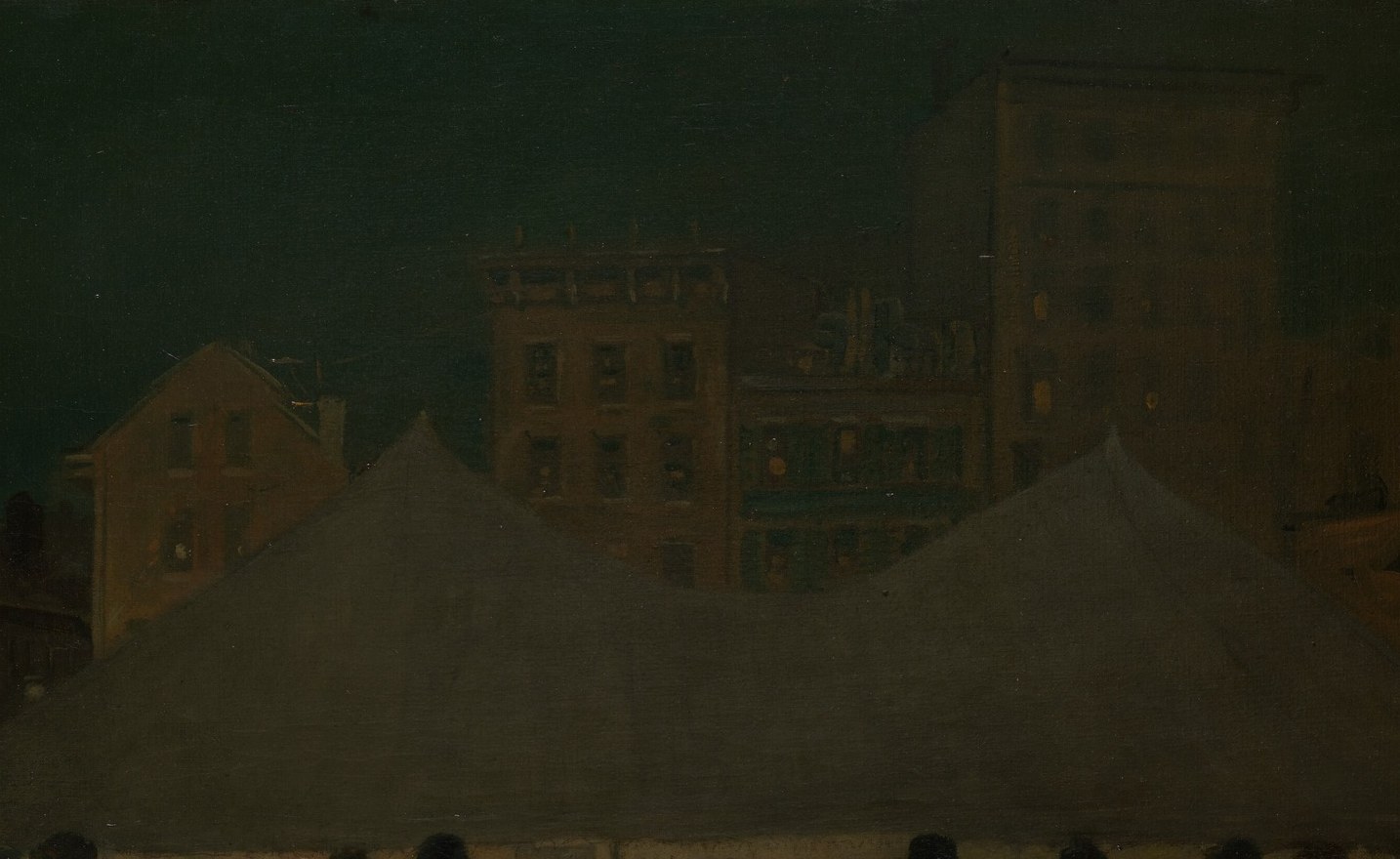 A tent glows on a dark street. A crowd gathers.