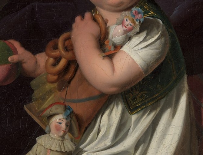 Look at his hands. He clutches a doll like a possession.