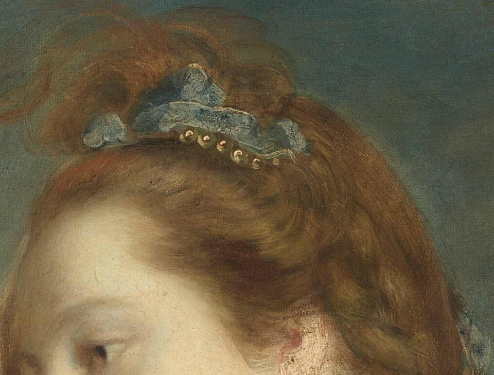 Her elaborate hair is pulled back with an ornament.