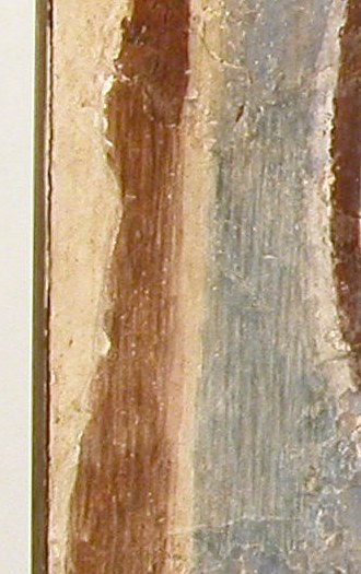 Beneath the damage, a fragment of red appears.