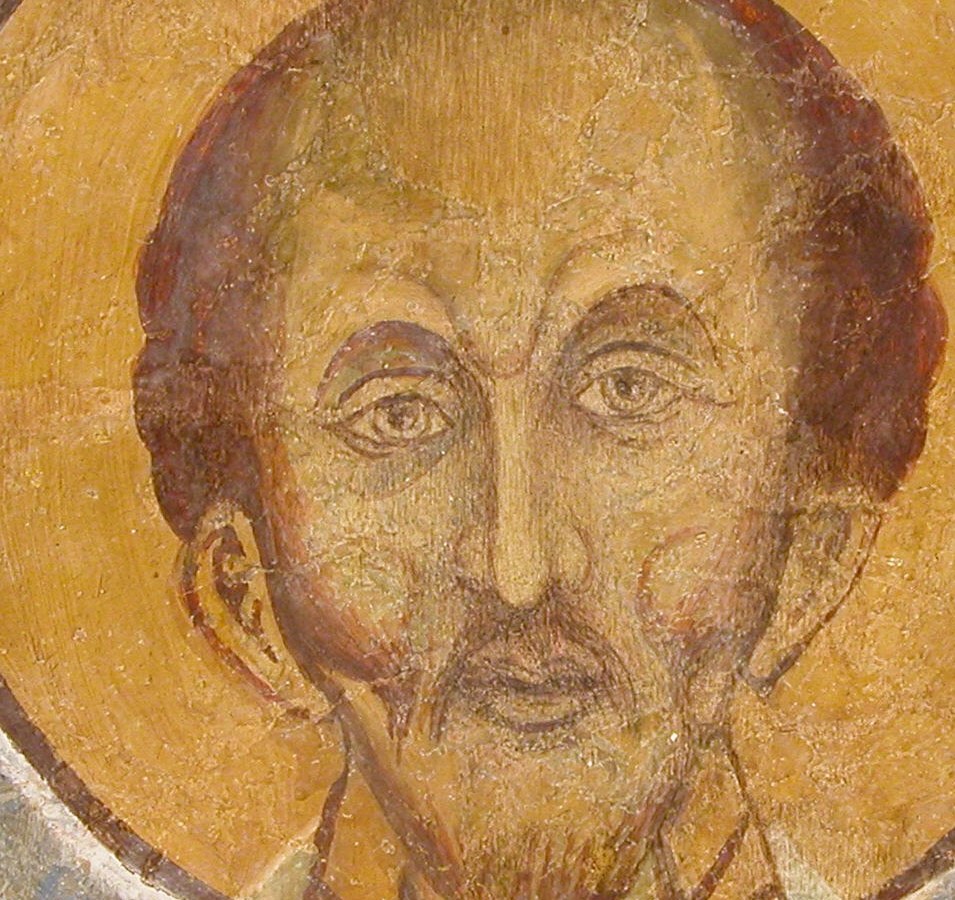 Only the saint's face and halo remain clear.
