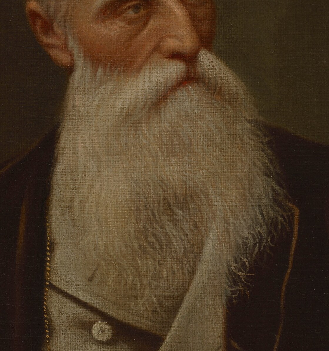 His long white beard shows wisdom, and age.