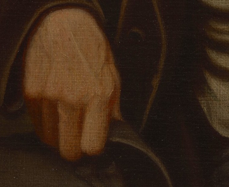 Look closely at his right hand, resting on his knee.