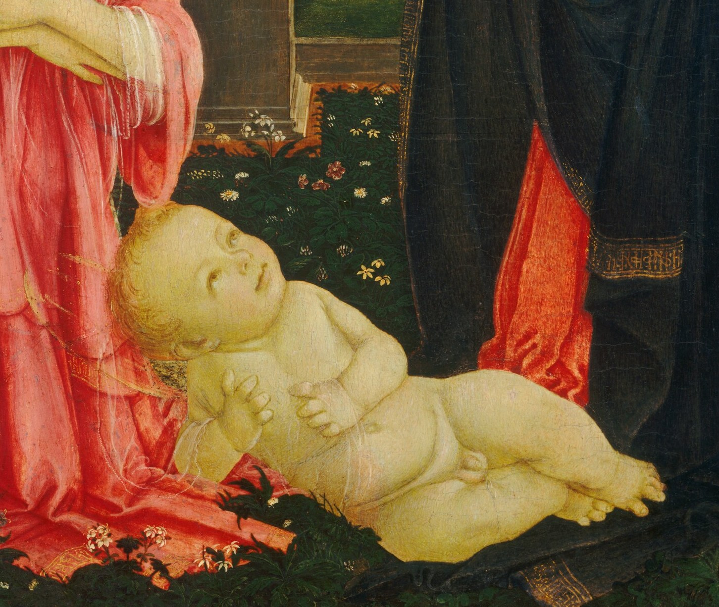 The newborn Christ Child rests on bare earth, not a manger.