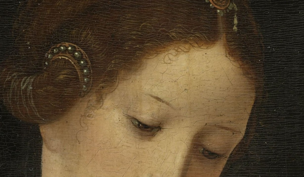 The gaze averted downward toward the child rather than the viewer creates introspection; a close-up reveals delicate modeling of the lids.