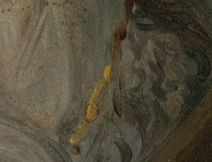 A subtle gold thread adds richness to her simple shawl.