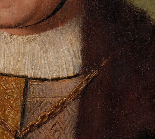The crisp, starched collar contrasts with his dark attire, drawing attention to his face.