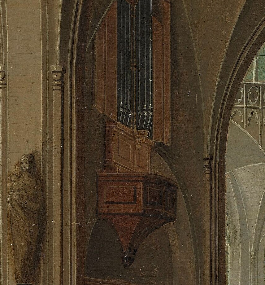 A prominent architectural feature, its pipes and wooden casing suggest the grandeur and soundscape of the church.