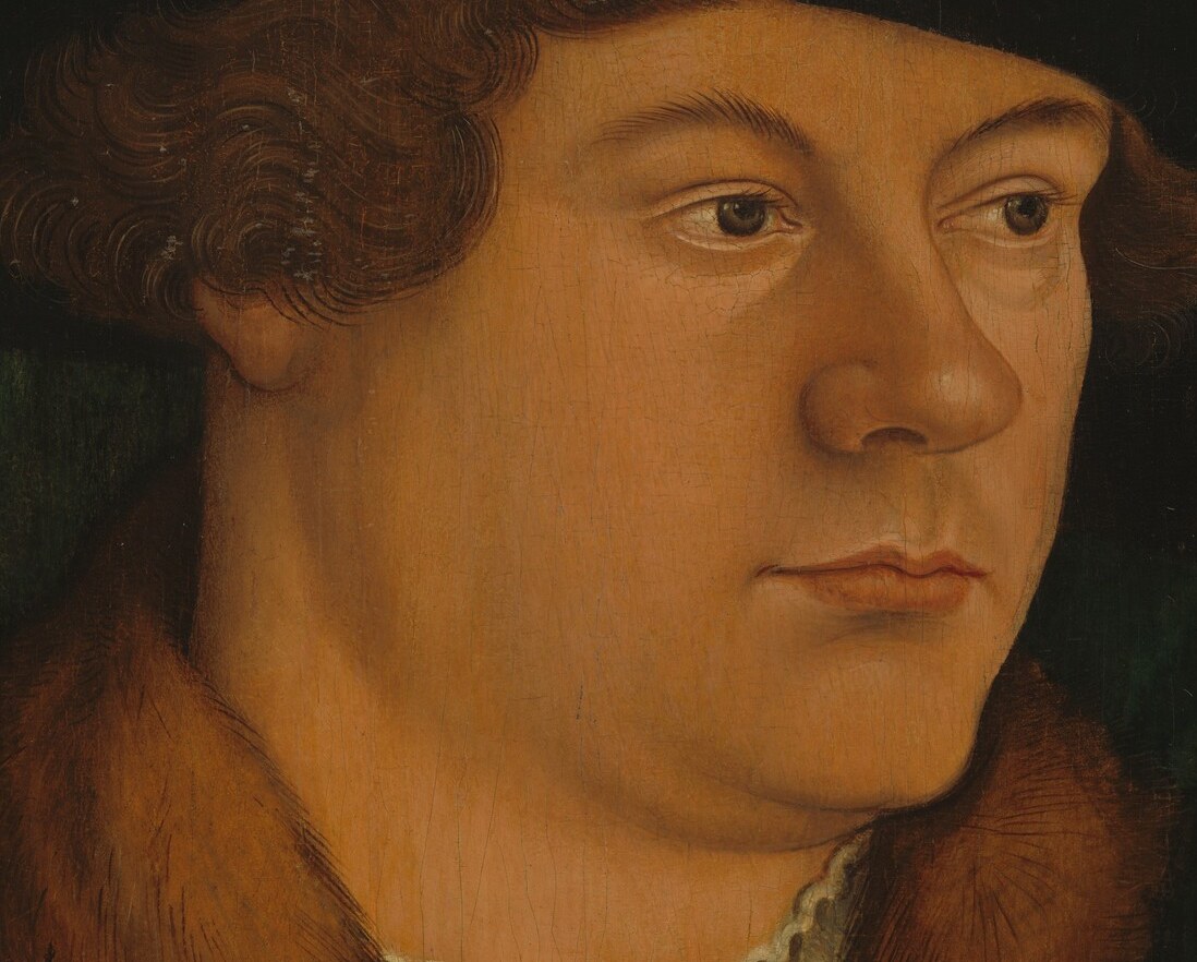 His direct, somber gaze conveys a sense of gravitas and introspection.