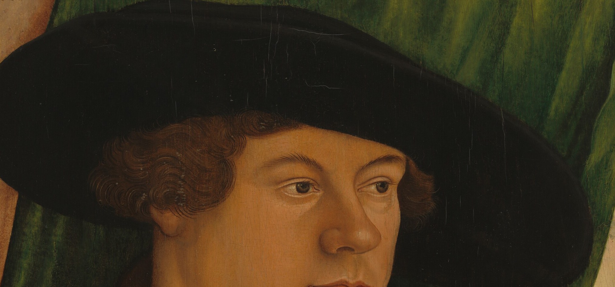 The wide brim and dark color create a strong silhouette, emphasizing his status.
