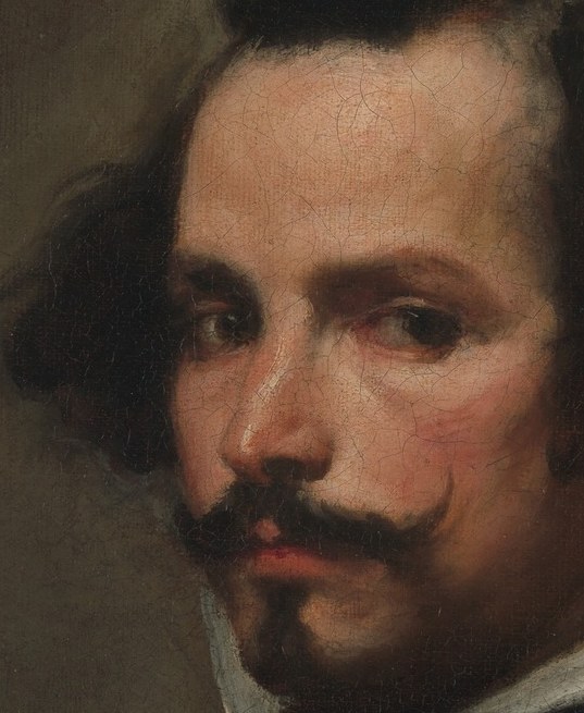 His direct gaze and slightly furrowed brow convey a sense of introspection or perhaps mild apprehension.