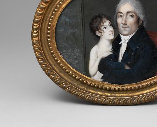 Her white muslin dress and loose curls mark the fashion of 1805.