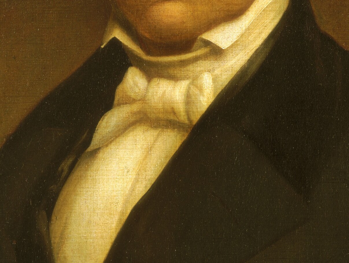 A burst of white against the dark coat; the loosely tied cravat is a period-specific detail that dates the portrait precisely to pre-Civil War American fashion.