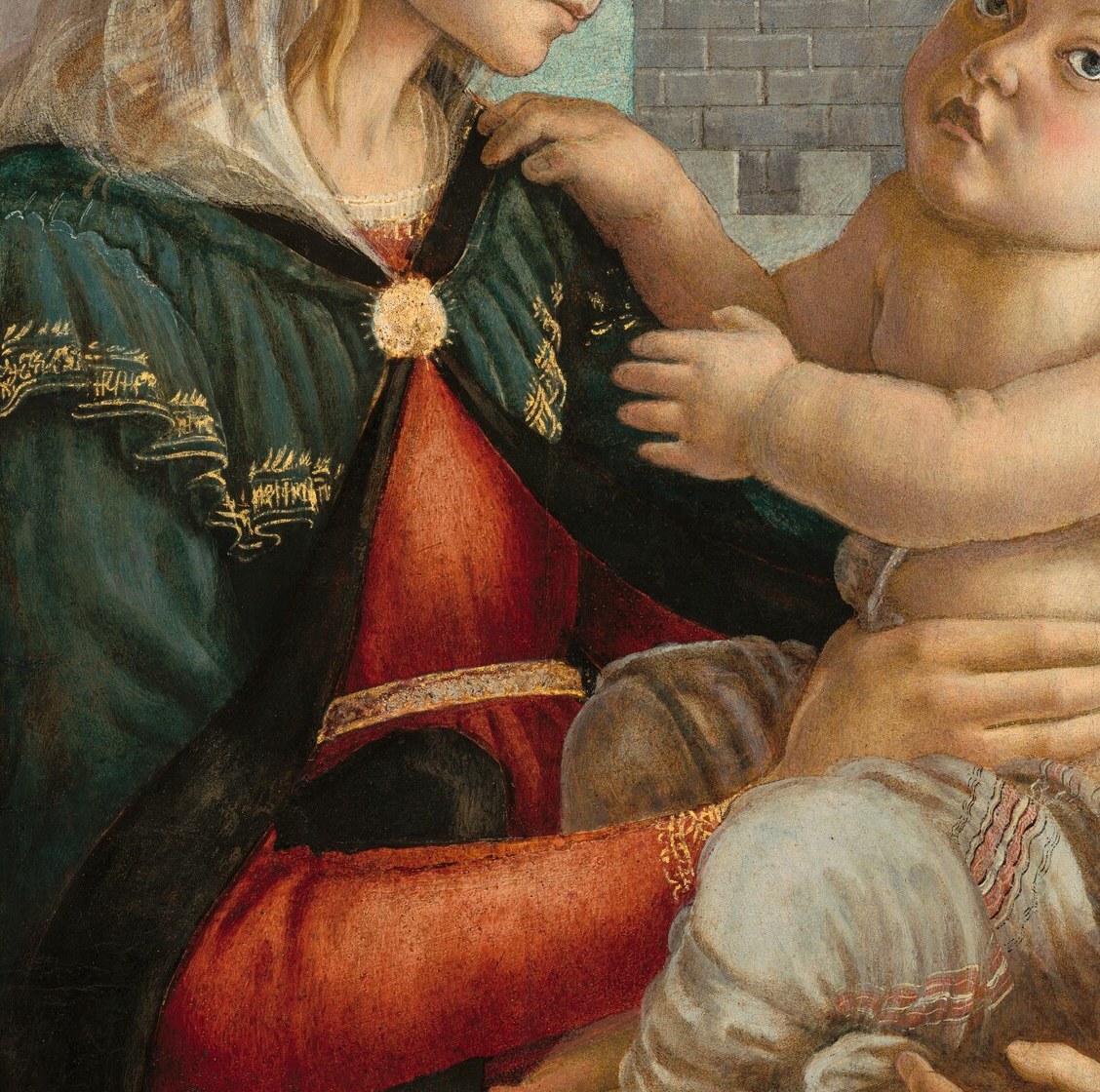 Her hands gently cradle the Christ Child's body.