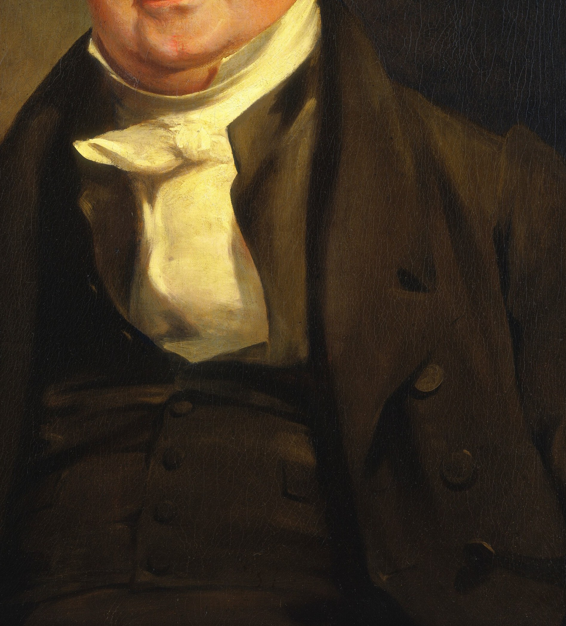 His dignified posture and formal attire speak to his role.