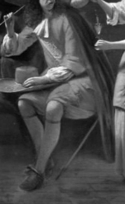 His relaxed posture and the hat in his hand suggest a moment of leisure or waiting.