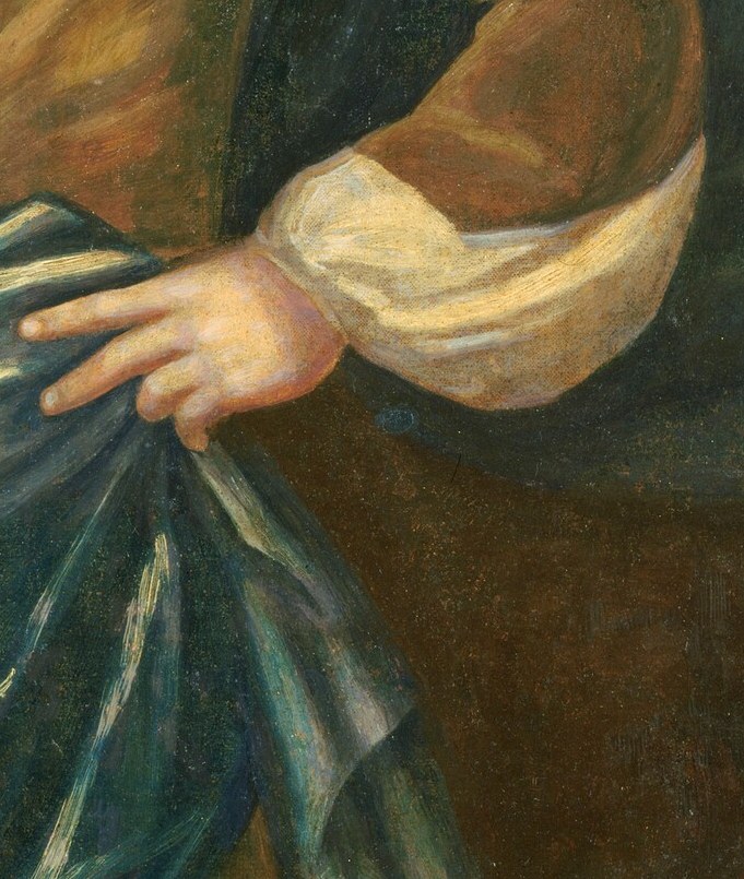 His stiff pose, with a hand on the hip, signals authority.