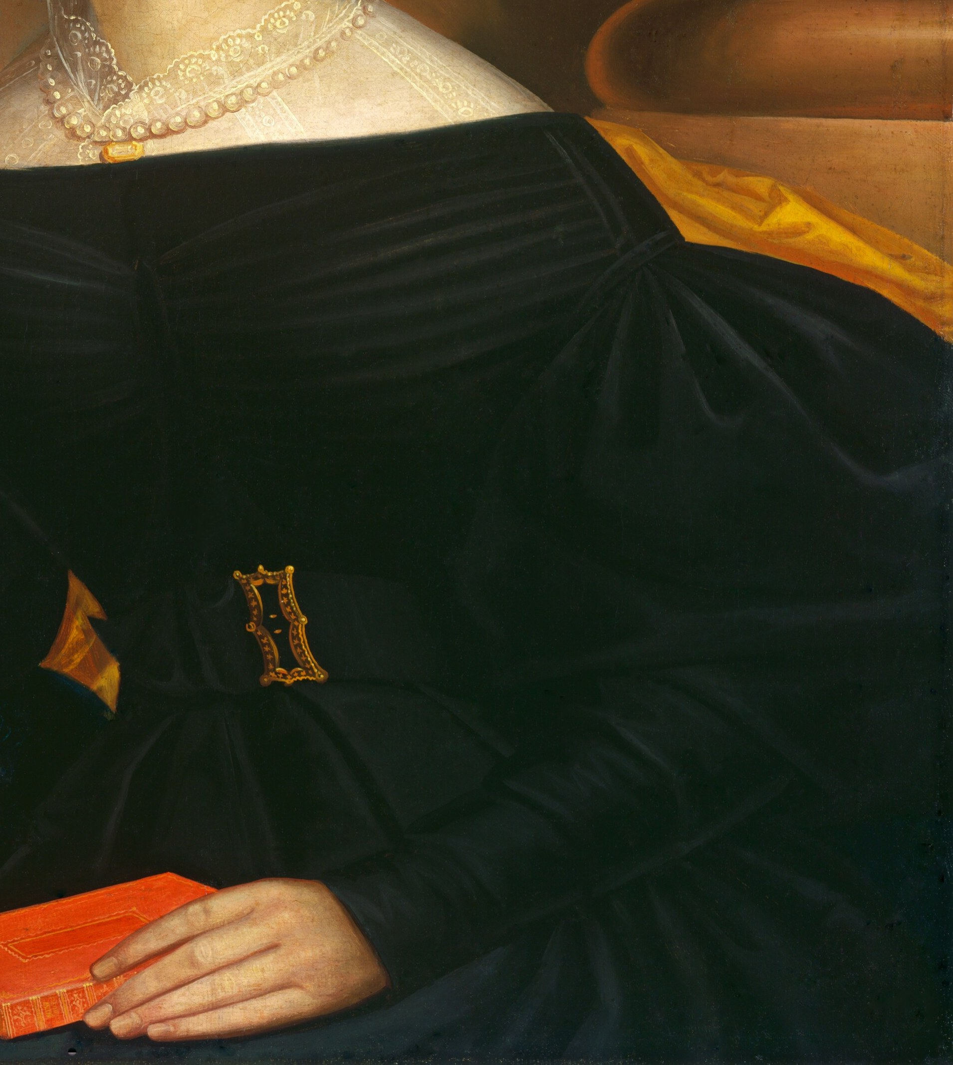 She wears a fashionable black dress, adorned with pearls.