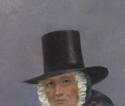 The tall black hat marks her office.