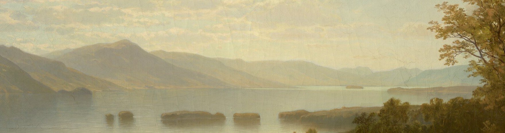 The still water acts as a second sky, reflecting the clouds and mountains in a pale silver band that anchors the composition's sense of perfect stillness