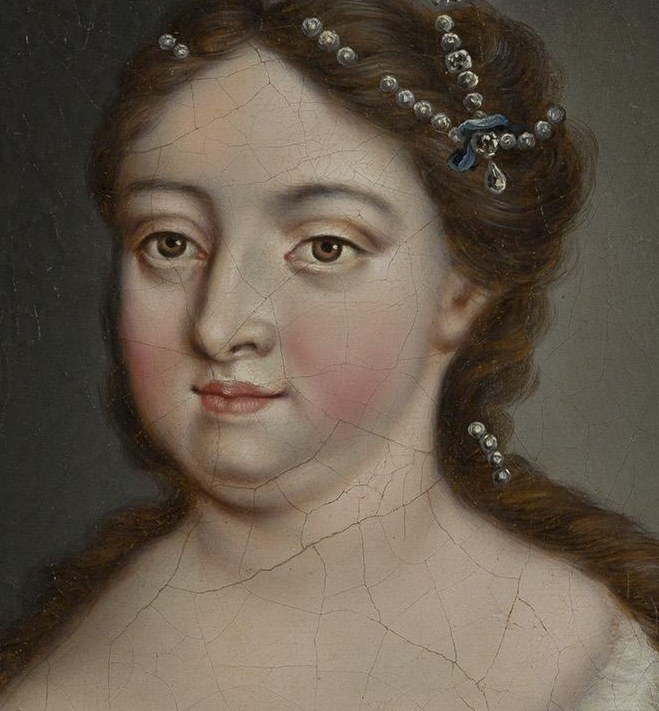 Her direct gaze and slightly parted lips convey a sense of regal composure and perhaps a hint of introspection.