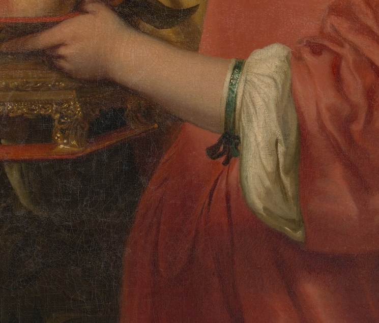 The grapes, dark and pale, mean the wine of the Eucharist.