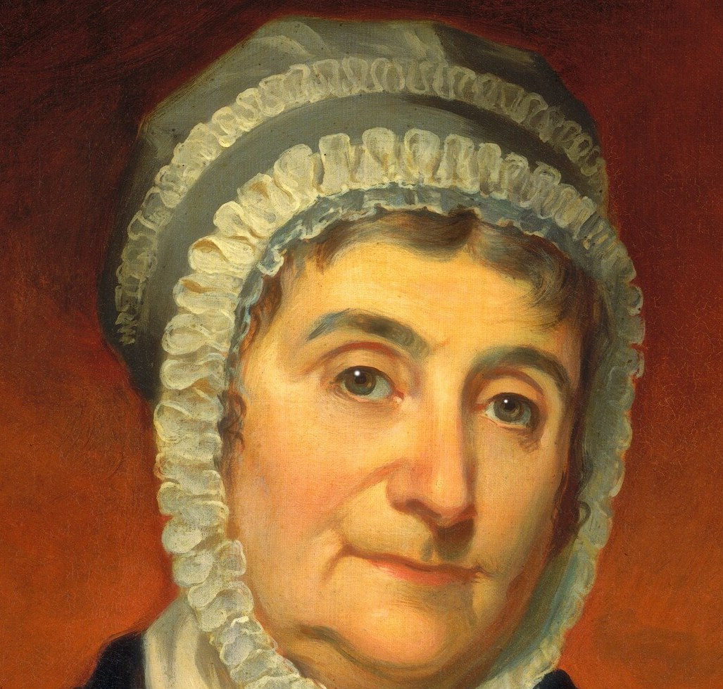 Her ruffled bonnet, the height of early 19th-century fashion.