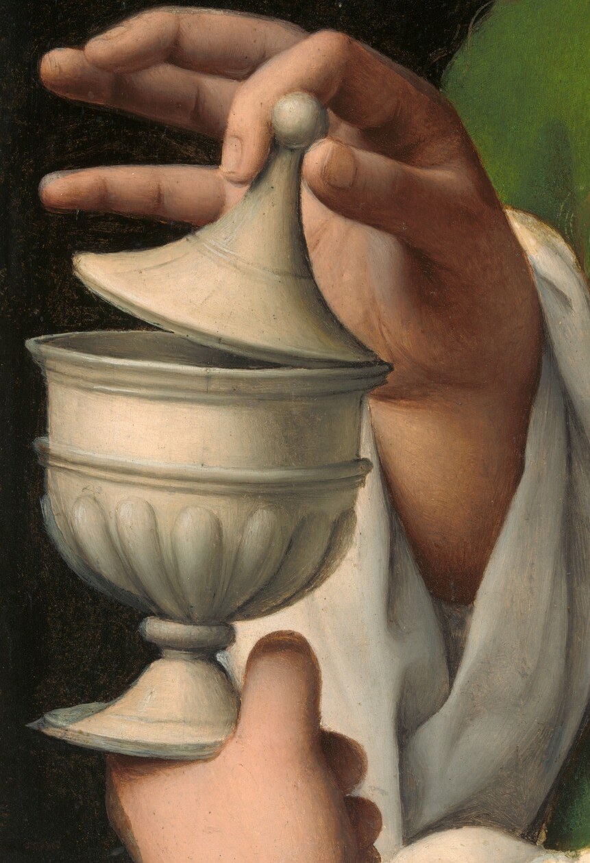 She is often shown with an ointment jar.