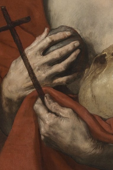 In his hands, the symbols of his devotion and mortality.
