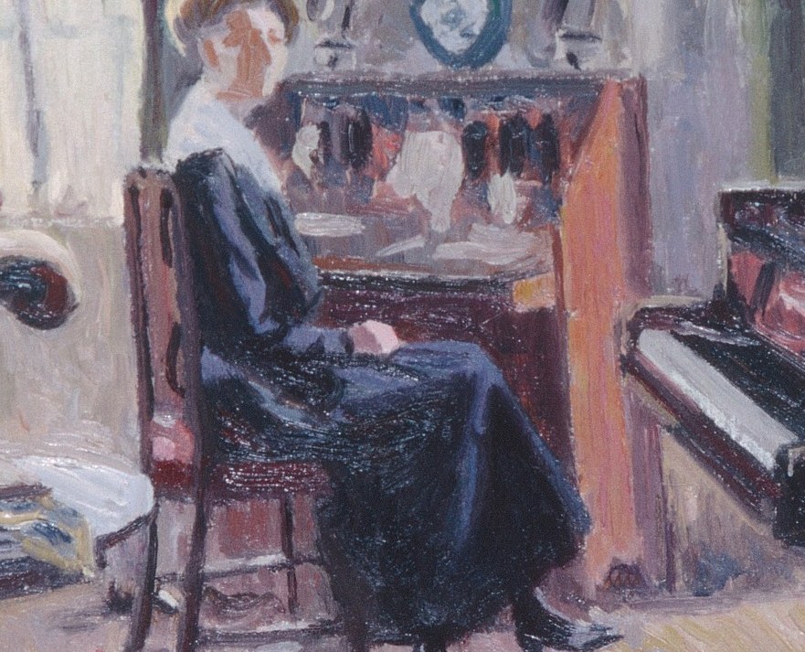 She is not at the piano. She sits at a writing desk.