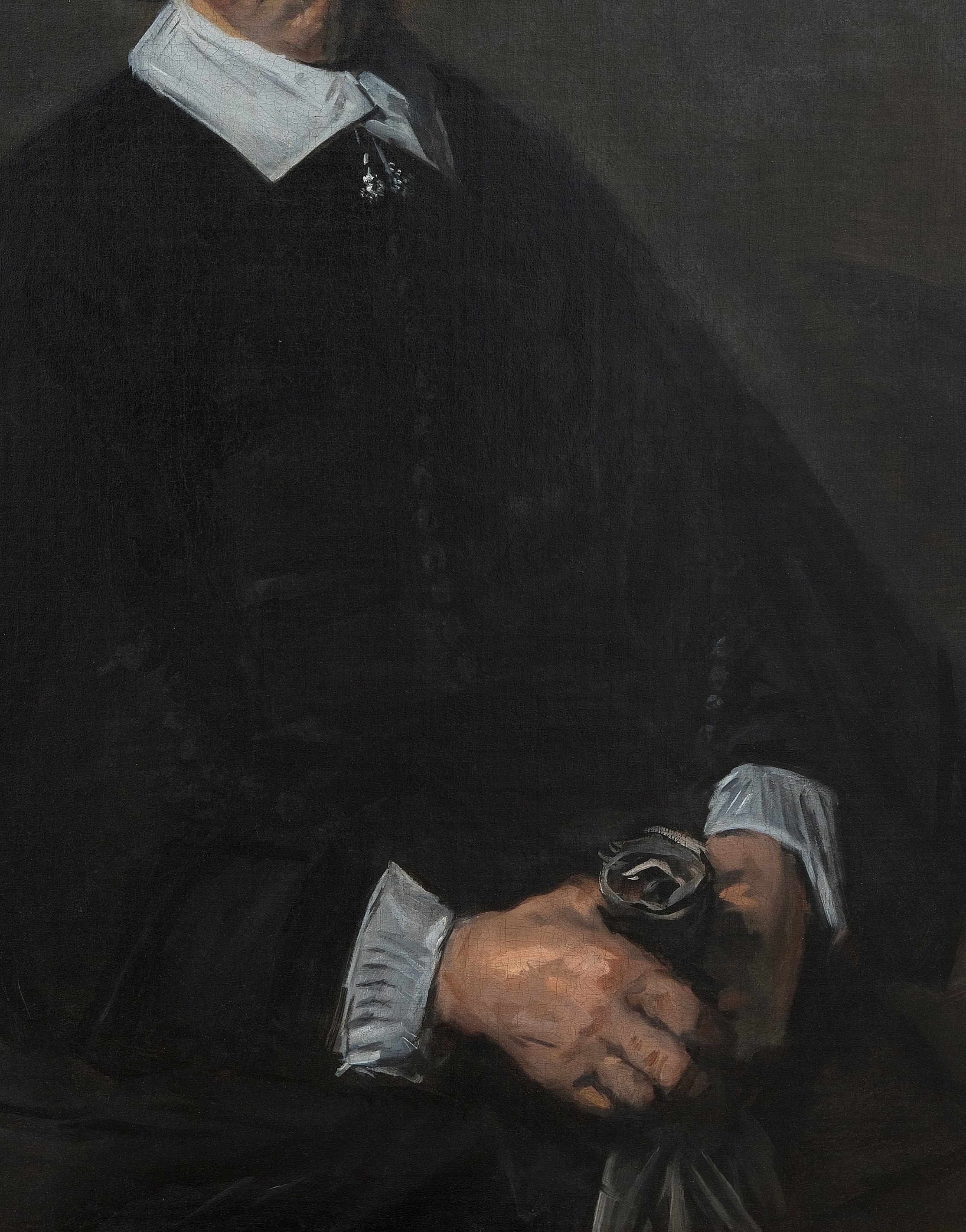 Notice his formal, dark jacket and crisp white collar.
